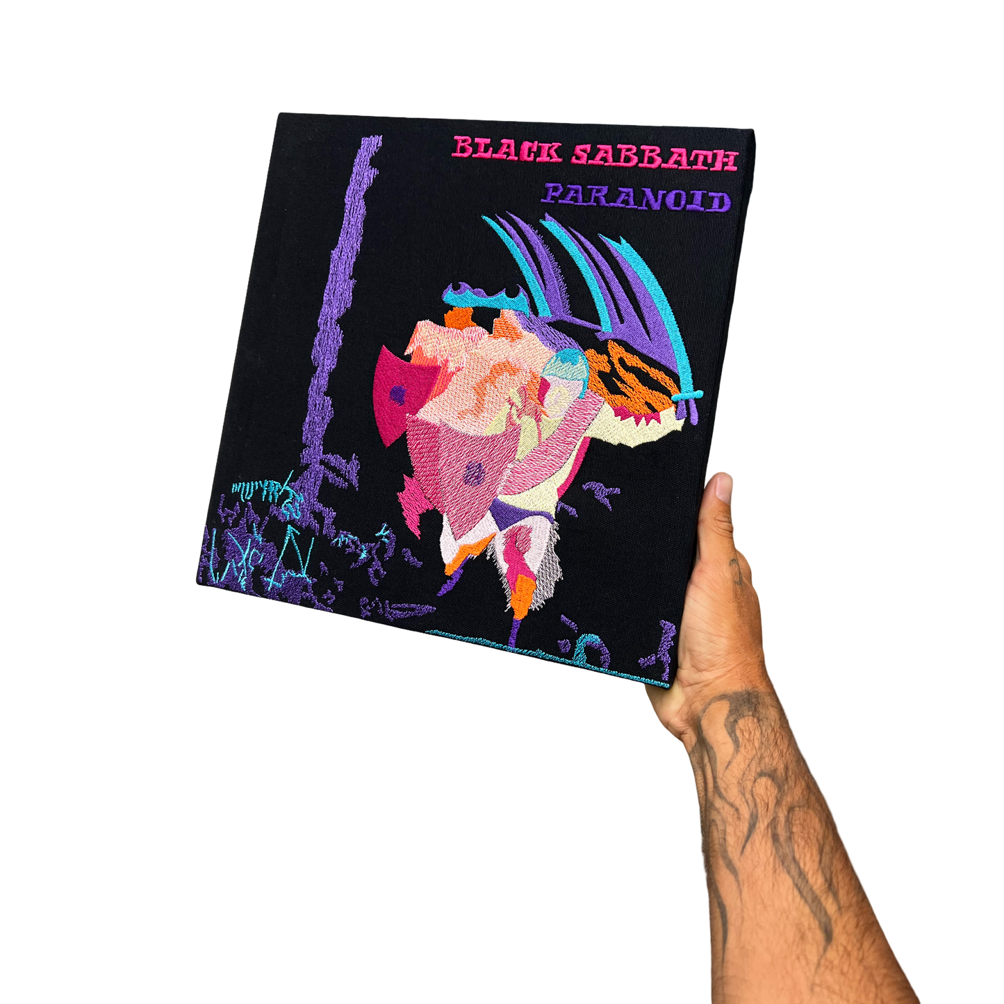 Hand holding a Black Sabbath 'Paranoid' album cover